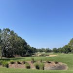 Panoramic view of a lush green golf course at Southern Dunes Golf and Country Club. Smooth