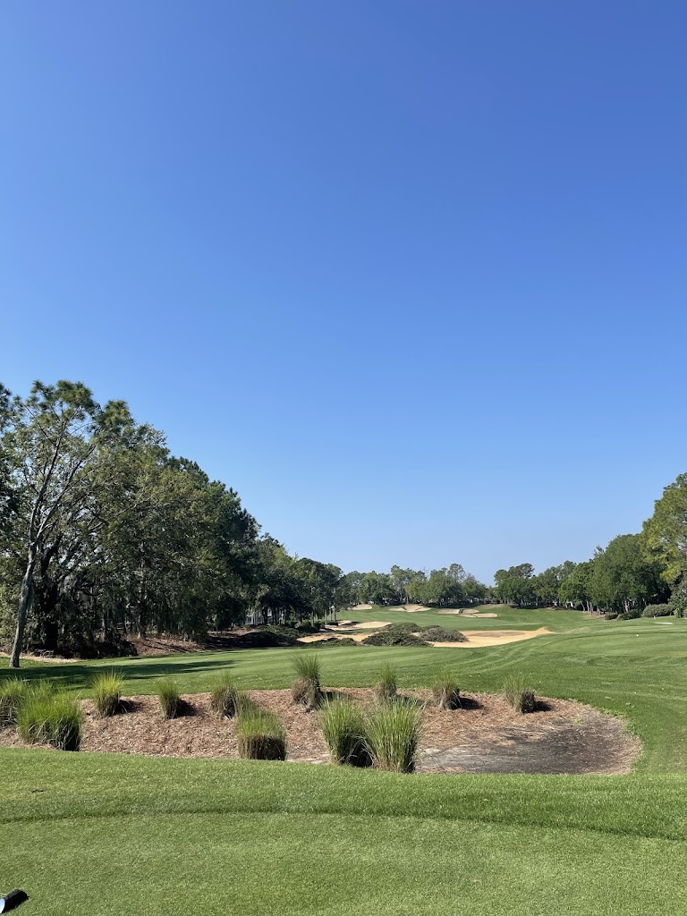 Panoramic view of a lush green golf course at Southern Dunes Golf and Country Club. Smooth