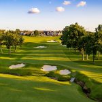 Panoramic view of a lush green golf course at Southern Hills Country Club. Smooth