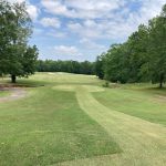 Panoramic view of a lush green golf course at Southern Hills Golf & Country Club. Smooth