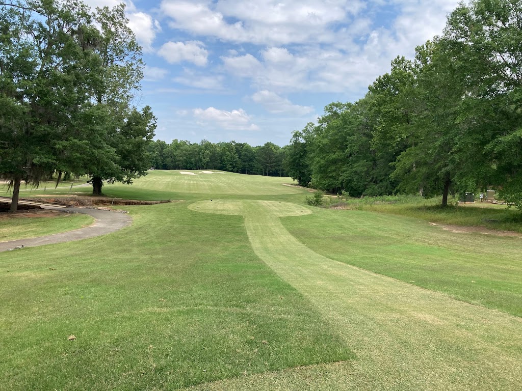 Panoramic view of a lush green golf course at Southern Hills Golf & Country Club. Smooth