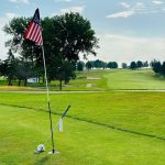 green grass with the flag in the hole.