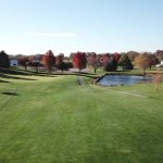 Panoramic view of a lush green golf course at Southern Hills Golf Course. Smooth