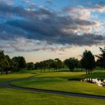 Panoramic view of a lush green golf course at Southern Hills Golf Course. Smooth
