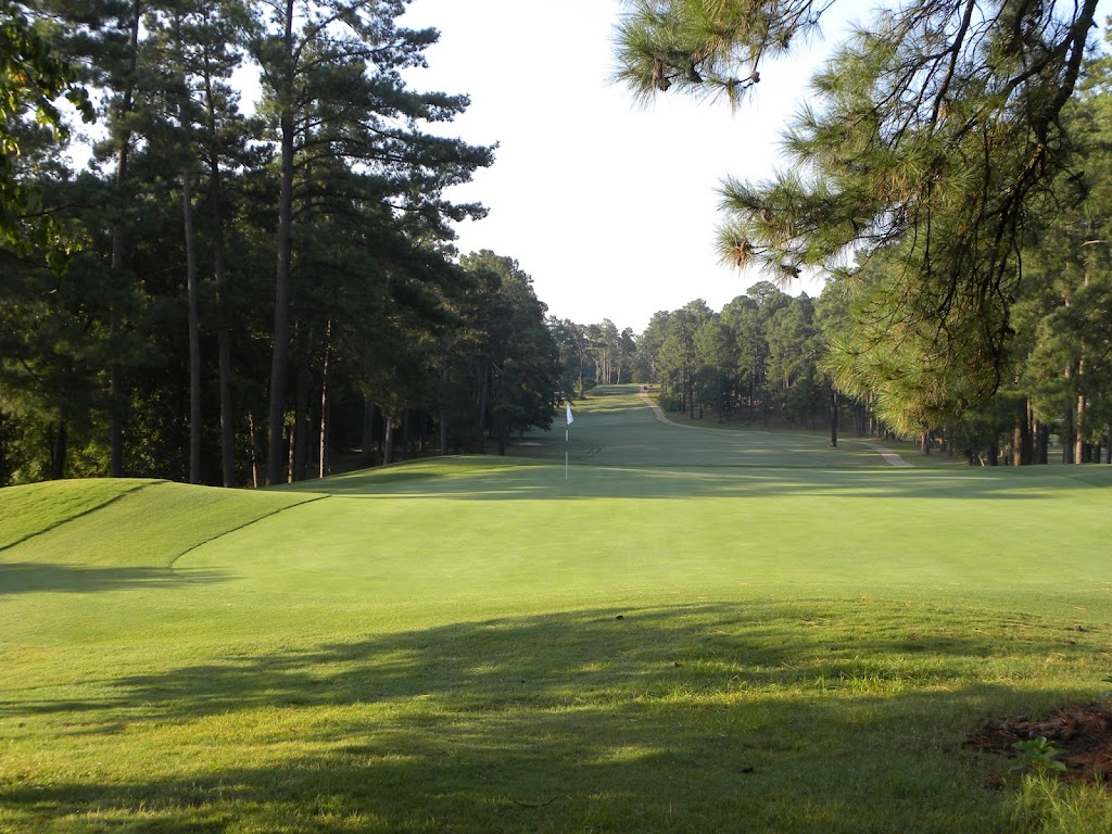 Panoramic view of a lush green golf course at Southern Pines Golf Club. Smooth