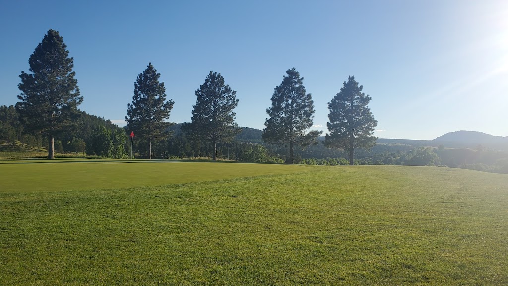 Panoramic view of a lush green golf course at Spearfish Canyon Golf Club. Smooth
