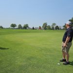 Panoramic view of a lush green golf course at Spencer Municipal Golf Course. Smooth