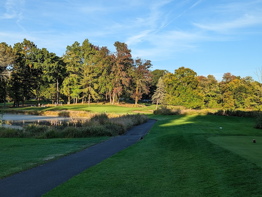 Panoramic view of a lush green golf course at Spook Rock Golf Course. Smooth