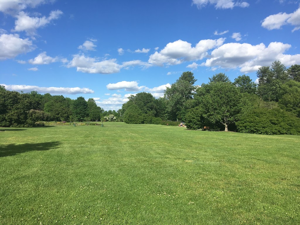 Panoramic view of a lush green golf course at Spooky Brook Public Golf Course. Smooth