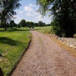 Panoramic view of a lush green golf course at Spring Creek Golf Course. Smooth