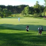 Panoramic view of a lush green golf course at Spring Hill Golf Club. Smooth