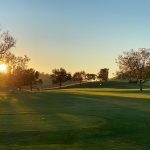 Panoramic view of a lush green golf course at Spring Valley Golf Course. Smooth