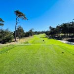 Panoramic view of a lush green golf course at Spyglass Hill Golf Course. Smooth