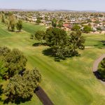Panoramic view of a lush green golf course at Stardust Golf Course. Smooth