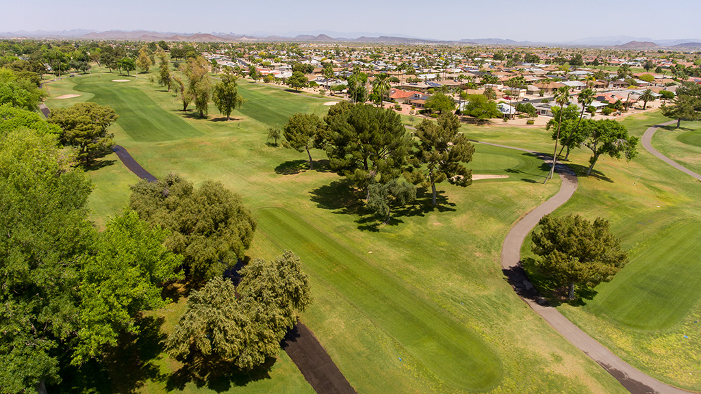 Panoramic view of a lush green golf course at Stardust Golf Course. Smooth