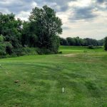 green grass with the flag in the hole.