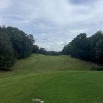 Panoramic view of a lush green golf course at Stillwaters Golf Course. Smooth
