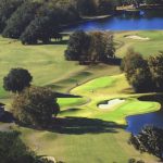 Panoramic view of a lush green golf course at Stone Creek Golf Club. Smooth