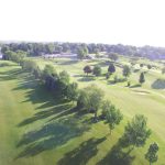 Panoramic view of a lush green golf course at Stone Creek Golf Club. Smooth