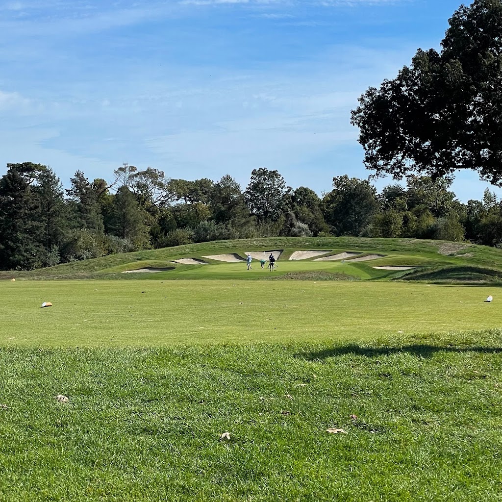 Panoramic view of a lush green golf course at Stone Harbor Golf Club. Smooth