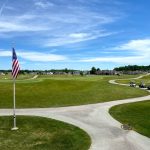 Panoramic view of a lush green golf course at Stone Ridge Golf Club. Smooth