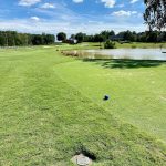 Panoramic view of a lush green golf course at Stonebridge Golf Club. Smooth