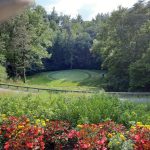 Panoramic view of a lush green golf course at Stonehenge Golf Club. Smooth