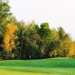 Panoramic view of a lush green golf course at Stones Throw Golf Course. Smooth