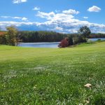 Panoramic view of a lush green golf course at Stonewall Golf Club. Smooth