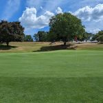 Panoramic view of a lush green golf course at Stony Ford Golf Course. Smooth