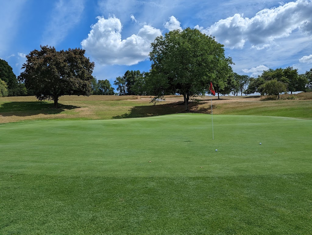 Panoramic view of a lush green golf course at Stony Ford Golf Course. Smooth