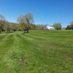 Panoramic view of a lush green golf course at Stonybrook Golf & Clubhouse Provisions. Smooth