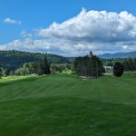 Panoramic view of a lush green golf course at Stowe Country Club. Smooth