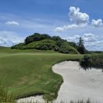Panoramic view of a lush green golf course at Streamsong Golf Course Red. Smooth