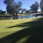 Panoramic view of a lush green golf course at Stripe Show Golf Club. Smooth