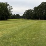 Panoramic view of a lush green golf course at Suffolk Golf Course. Smooth