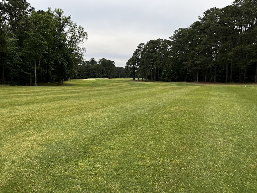 Panoramic view of a lush green golf course at Suffolk Golf Course. Smooth