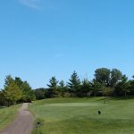 green grass with the flag in the hole.