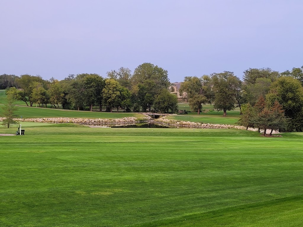 Panoramic view of a lush green golf course at Sugar Creek Golf Course. Smooth