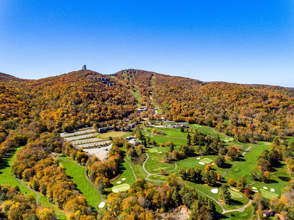Panoramic view of a lush green golf course at Sugar Mountain Public Golf Course. Smooth