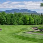 Panoramic view of a lush green golf course at Sugarloaf Golf Club. Smooth