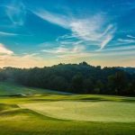 Panoramic view of a lush green golf course at Sultan's Run. Smooth