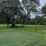 Panoramic view of a lush green golf course at Summit Municipal Golf Course. Smooth