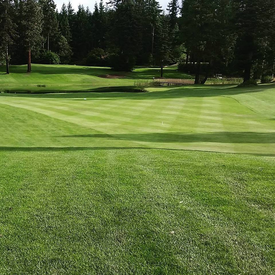 Panoramic view of a lush green golf course at Sun Country Golf Course. Smooth