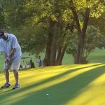 green grass with the flag in the hole.