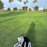 Panoramic view of a lush green golf course at Sun Village Golf Course. Smooth