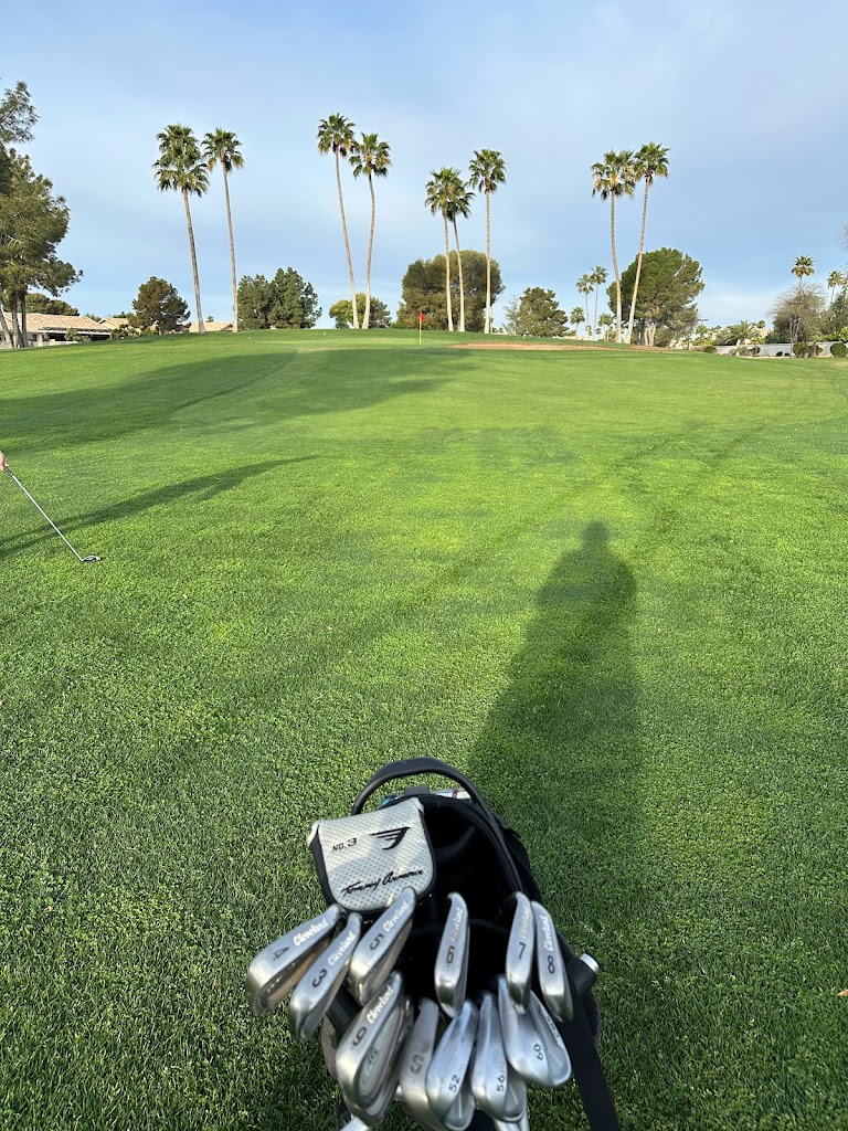 Panoramic view of a lush green golf course at Sun Village Golf Course. Smooth