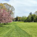 Panoramic view of a lush green golf course at Sunken Meadow Golf Course. Smooth