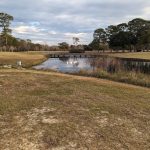 Panoramic view of a lush green golf course at Sunkist Country Club Bar & Grill. Smooth