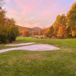 Panoramic view of a lush green golf course at Sunset Valley Golf Course. Smooth
